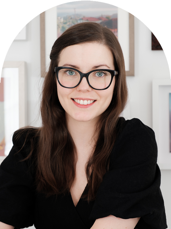 Portrait of Fiona smiling, against a gradient sky